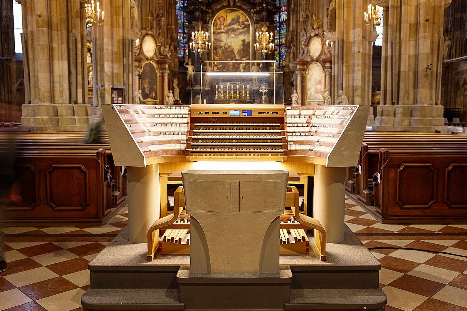 St. Stephen's Cathedral organ console in Vienna, Austria, with ornate interior details.