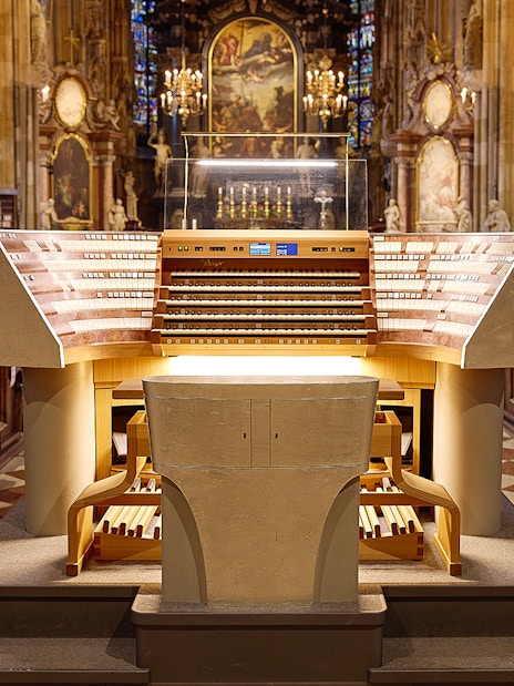 St. Stephen's Cathedral organ console in Vienna, Austria, with ornate interior details.