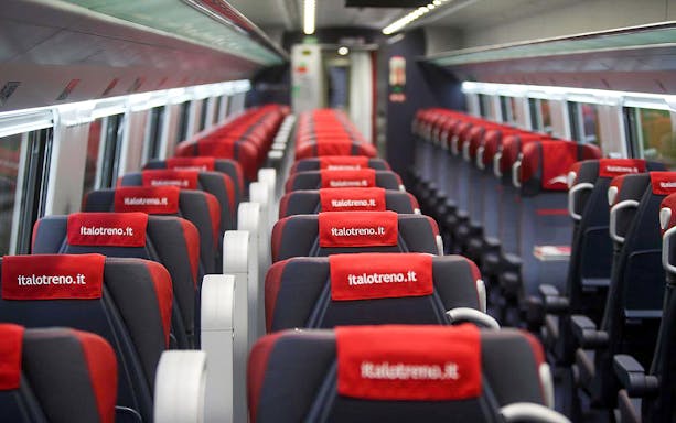 High-speed train interior from Florence to Venice with red and black seats.