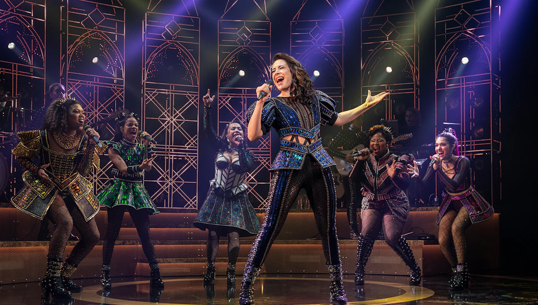 Performers on stage during SIX: The Musical, showcasing vibrant costumes and dynamic choreography.