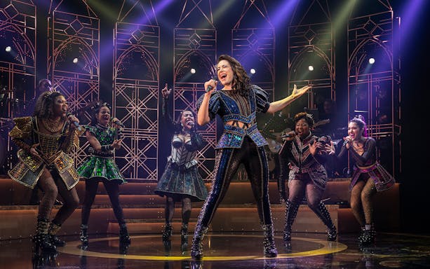Performers on stage during SIX: The Musical, showcasing vibrant costumes and dynamic choreography.