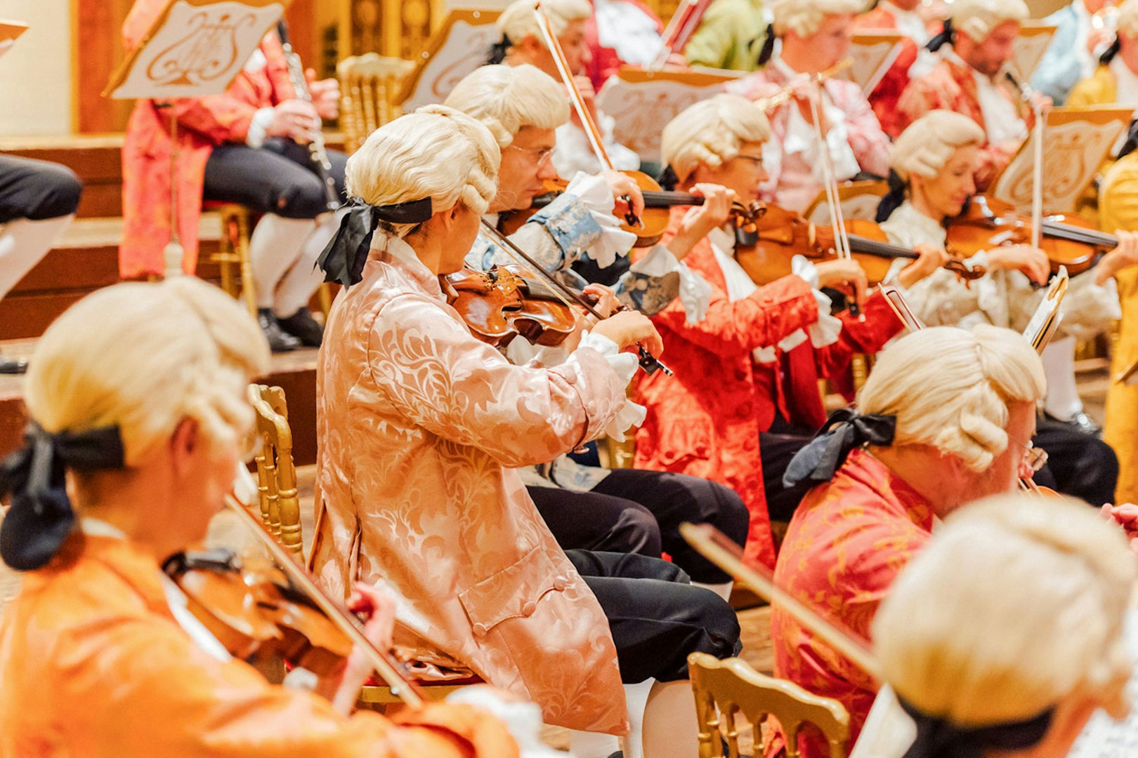Orchestra in period costumes performing at Vienna's Musikverein Golden Hall.