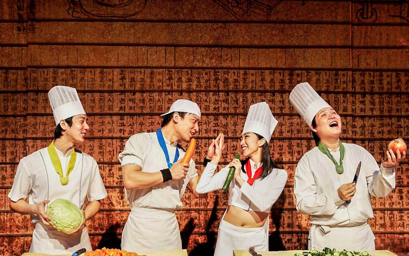Chefs performing a cooking show with vegetables in Nice.