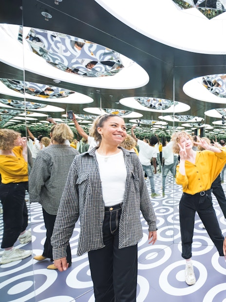 Visitors exploring mirrored room at Paradox Museum Stockholm.