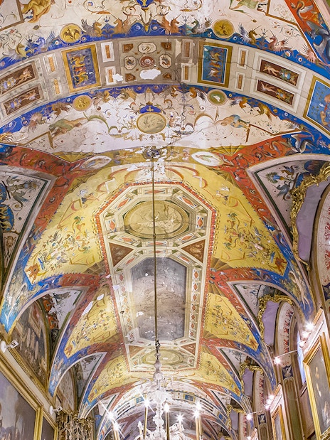 Doria Pamphilj Gallery ornate ceiling with vibrant frescoes and framed paintings.