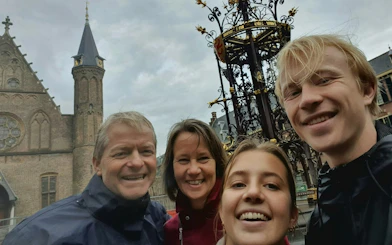 Group exploring The Hague's Old Town near historic architecture.