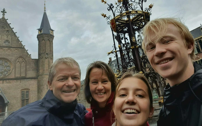 Group exploring The Hague's Old Town near historic architecture.