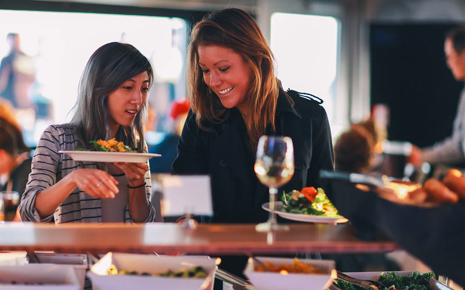 Guests selecting food at the Signature Bottomless Mimosa Brunch Cruise in Washington DC.