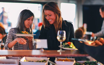 Guests selecting food at the Signature Bottomless Mimosa Brunch Cruise in Washington DC.