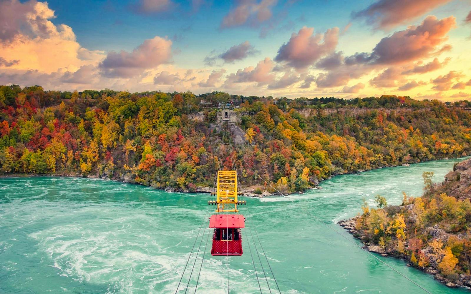 Aerial cable car over Niagara River with autumn foliage in Niagara Falls.