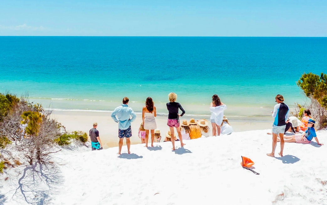 Tourists enjoying the beach view on Fraser Island, K'gari.