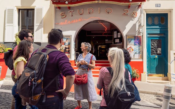 Tour group outside Studio 28 in Montmartre during guided walking tour.