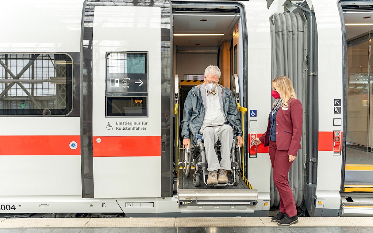 Wheelchair user assisted by staff on Eurail train in Germany.