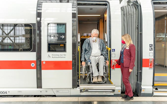 Wheelchair user assisted by staff on Eurail train in Germany.