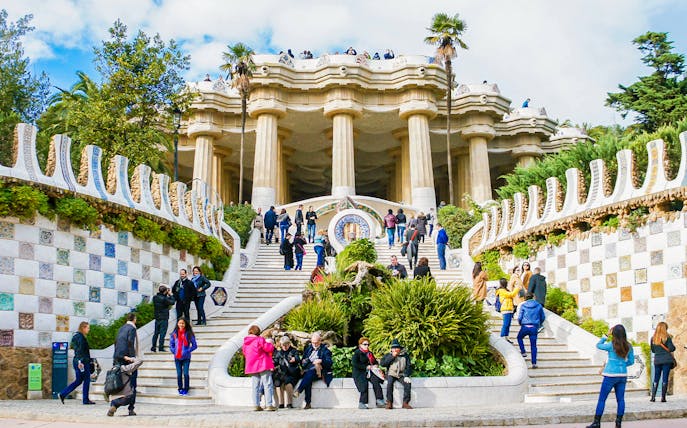 Visitors on the mosaic stairs of Park Güell, Barcelona.