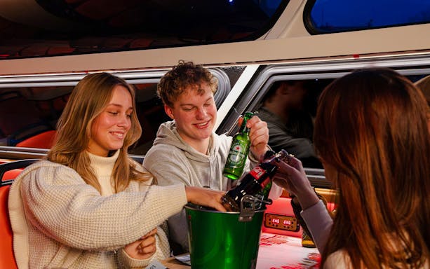Guests enjoying drinks on the Lovers Canal Cruise in Amsterdam.