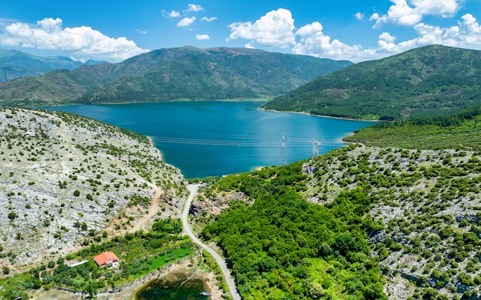 Aerial view of Vau i Dejës Lake surrounded by mountains in Shkoder, Albania.