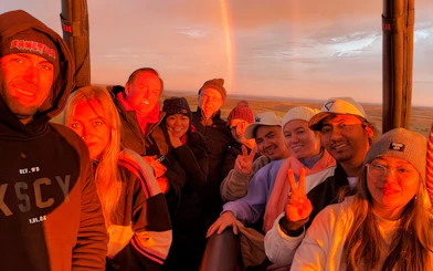 Tourists enjoying sunrise in a hot air balloon over Avon Valley.
