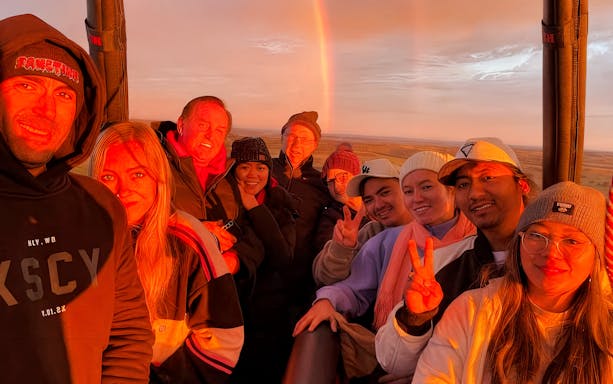 Tourists enjoying sunrise in a hot air balloon over Avon Valley.