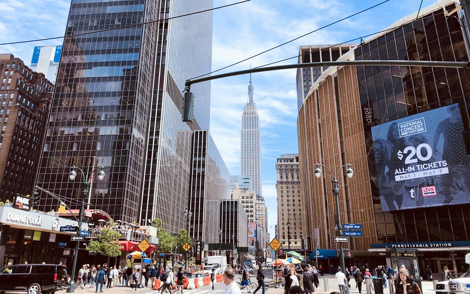 Busy New York street with Empire State Building in the background.
