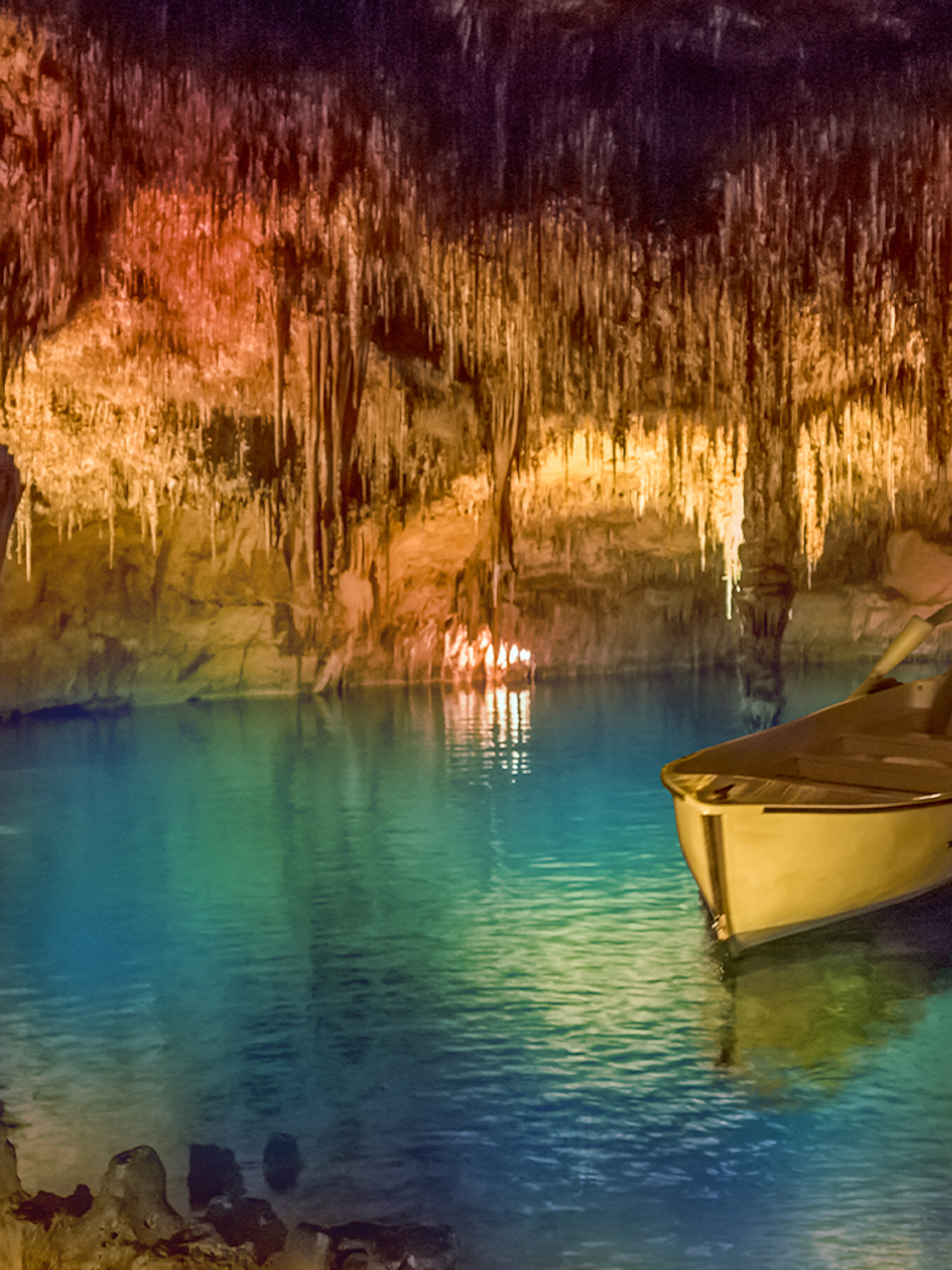 Boat ride through illuminated stalactites in Drach Caves, Mallorca.