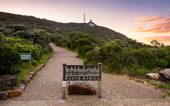 Cape Point sign with coordinates, path leading to lighthouse, Cape of Good Hope, South Africa.
