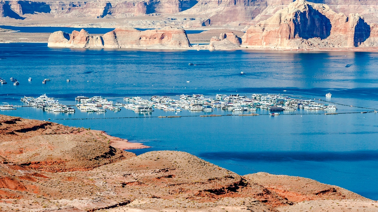 Marina with boats on Lake Mead, surrounded by red rock formations, between Nevada and Arizona.