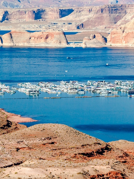 Marina with boats on Lake Mead, surrounded by red rock formations, between Nevada and Arizona.