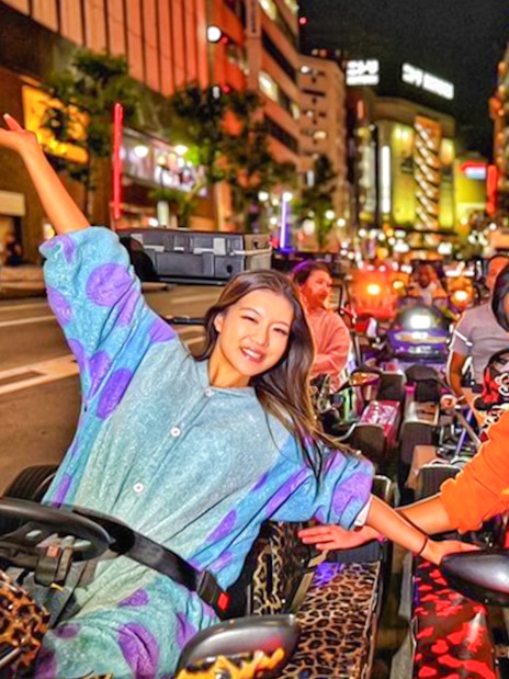 Group in go-karts at night near Shibuya Crossing, Tokyo.