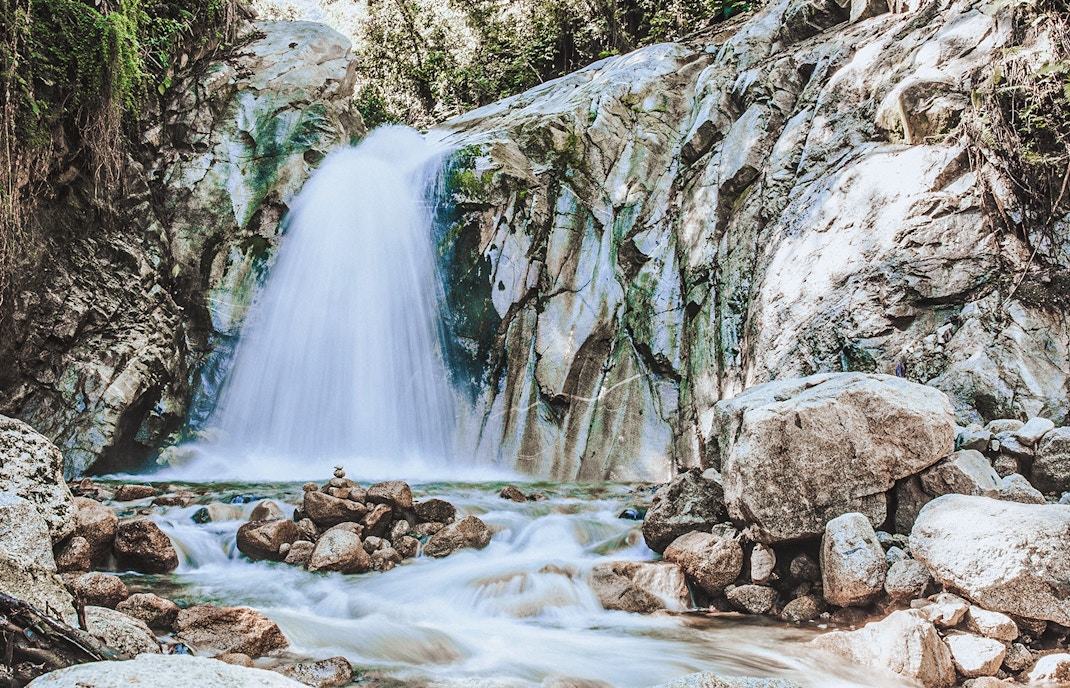 Mandor Waterfall cascading over rocks in a lush forest, Peru.