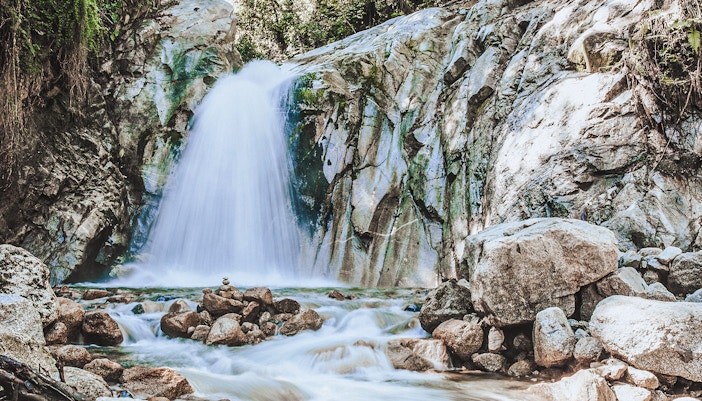 Mandor Waterfall cascading over rocks in a lush forest, Peru.
