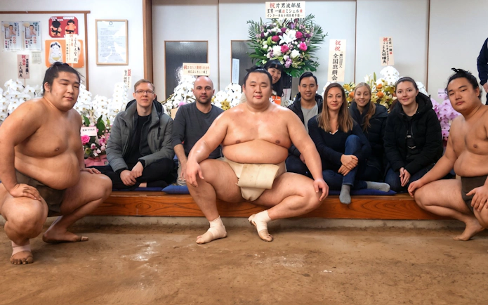 Sumo wrestlers and visitors at Tokyo Ryogoku Sumo Morning Practice.