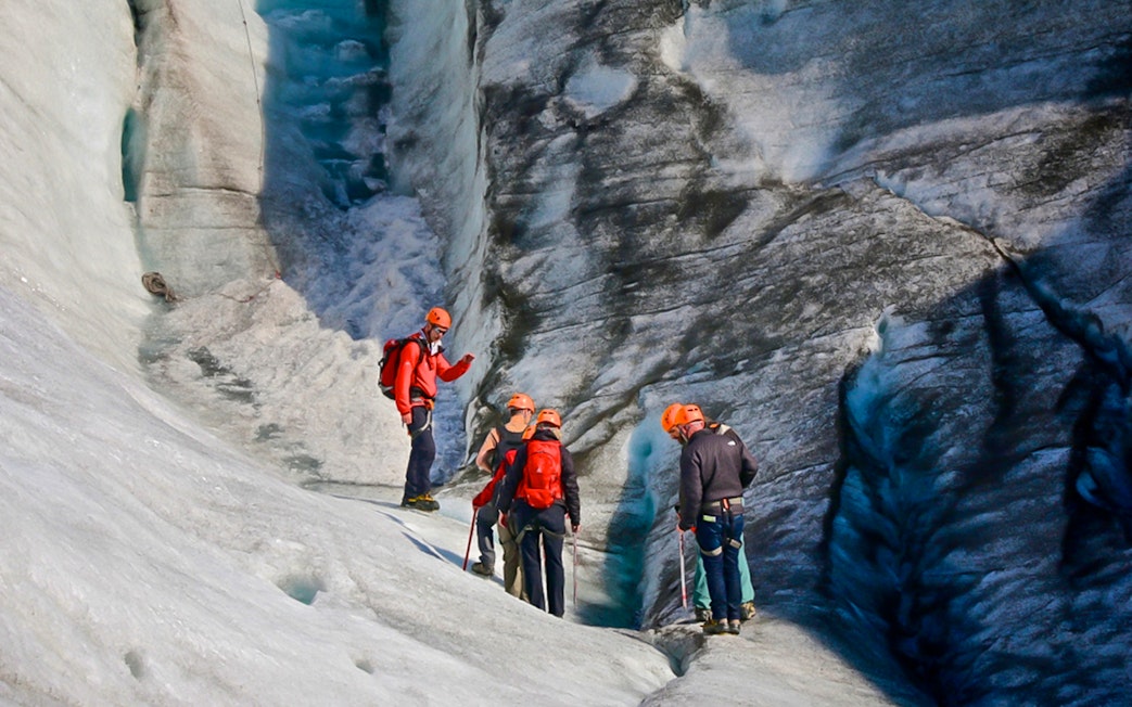 Guests hiking and ice climbing on a glacier in Skaftafell, Iceland.
