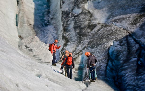 Guests hiking and ice climbing on a glacier in Skaftafell, Iceland.