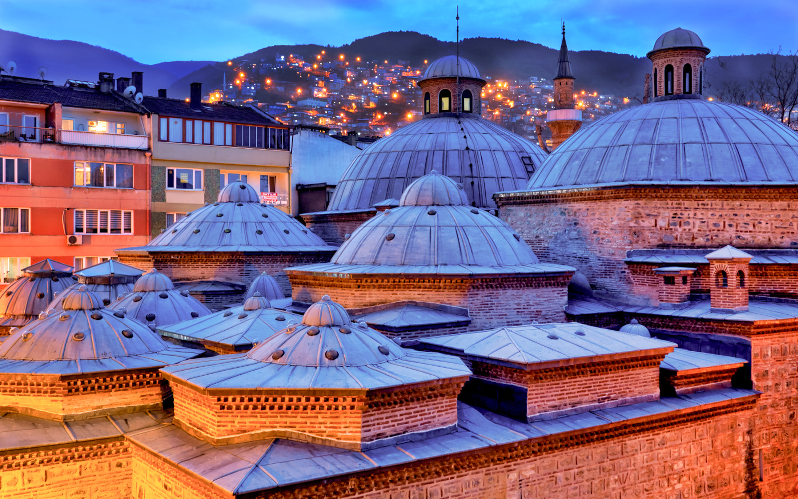 Bodrum Turkish Bath and Spa exterior at evening with illuminated entrance and traditional architecture.