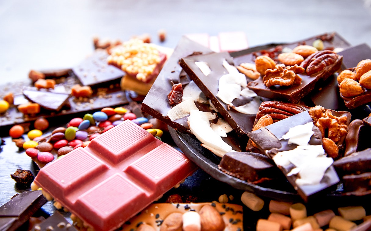 Assorted chocolates with nuts and toppings at Chocoversum, Hamburg.