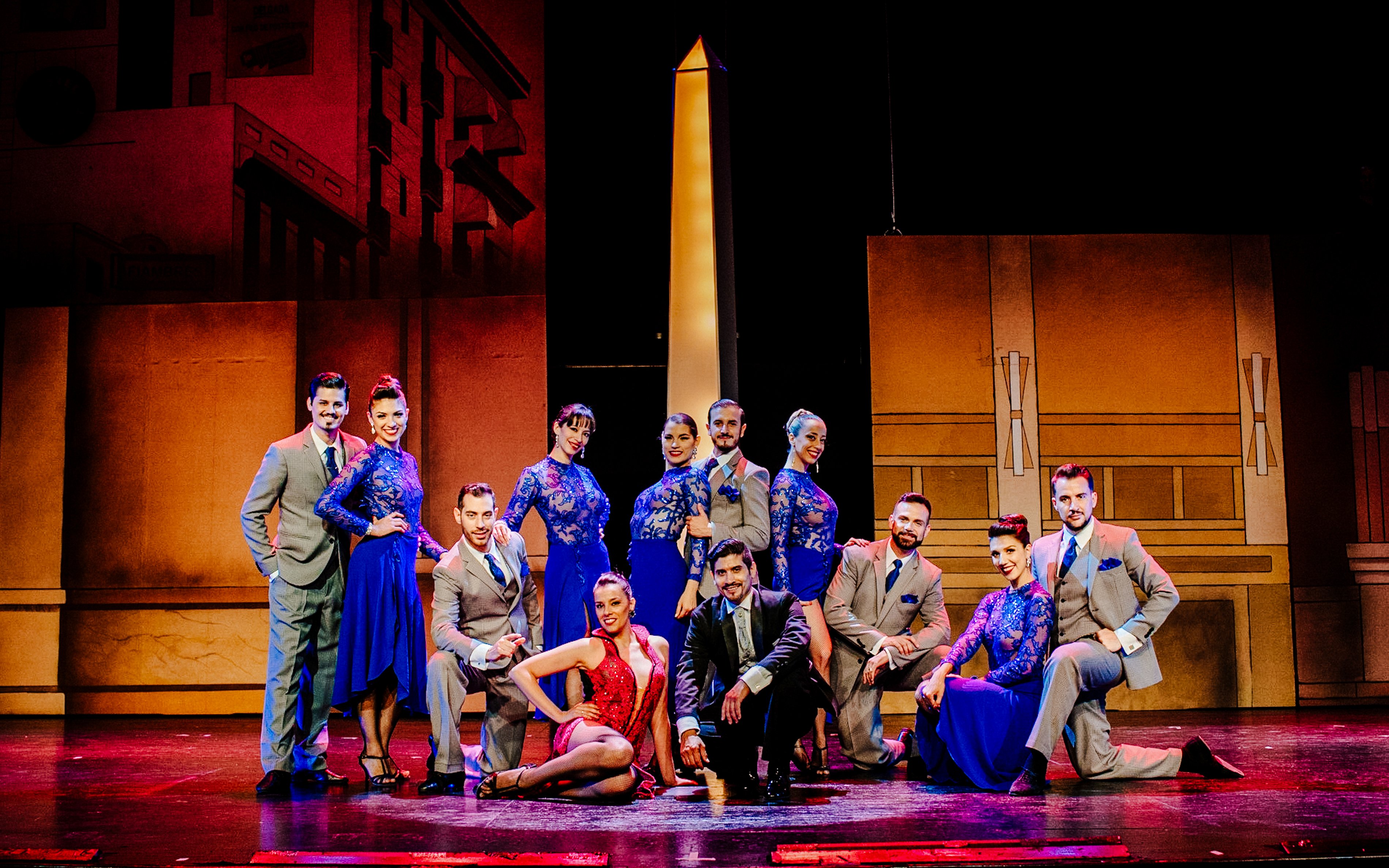 Tango dancers in vibrant costumes at Tango Porteño Show, Buenos Aires stage.