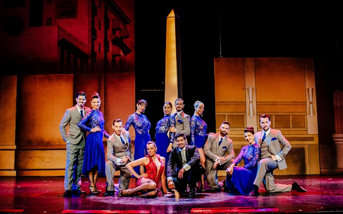 Tango dancers in vibrant costumes at Tango Porteño Show, Buenos Aires stage.