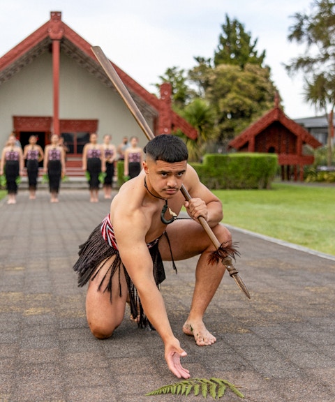 Maori performers in traditional attire performing a haka at Te Puia, Rotorua.