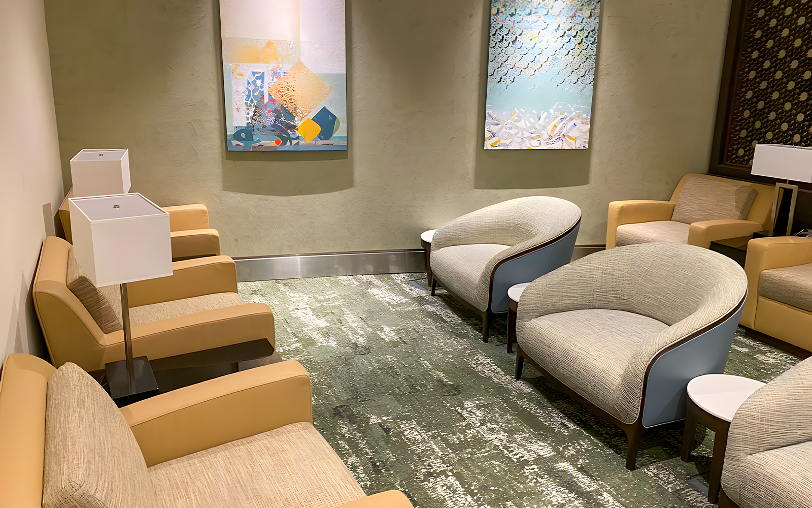 Premium lounge seating area at Jeddah Airport with modern chairs and artwork.