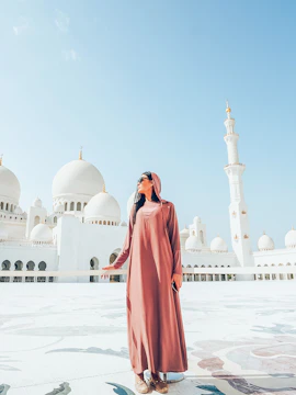 Woman in traditional attire at Sheikh Zayed Grand Mosque, Abu Dhabi.
