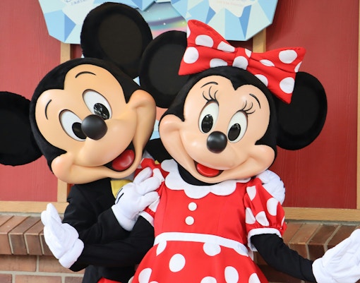 Mickey and Minnie Mouse greeting visitors at Disneyland Paris.