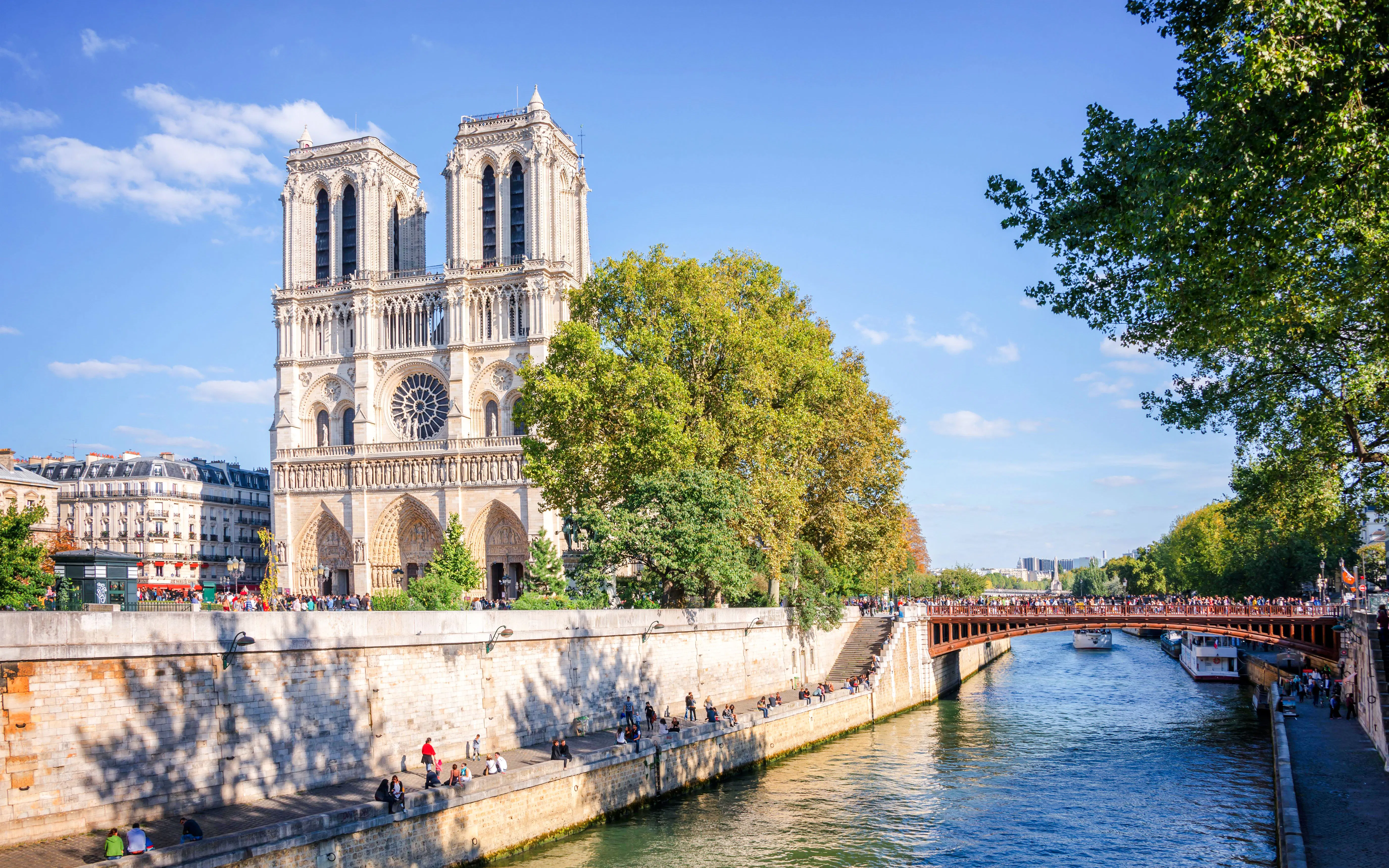 Facade of Notre Dame de Paris with River Seine in Paris, France, seen on a walking tour.