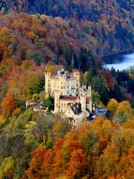 Hohenschwangau Castle surrounded by autumn foliage in Bavaria, Germany.