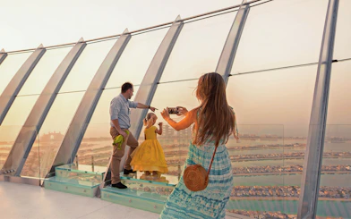 Family taking a photo at View at The Palm, Dubai, overlooking the Palm Jumeirah.