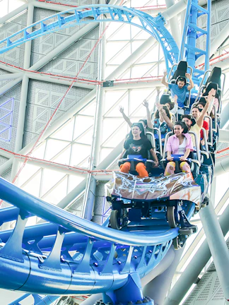 Riders on the Storm Coaster at Dubai Hills Mall, experiencing a thrilling indoor loop.