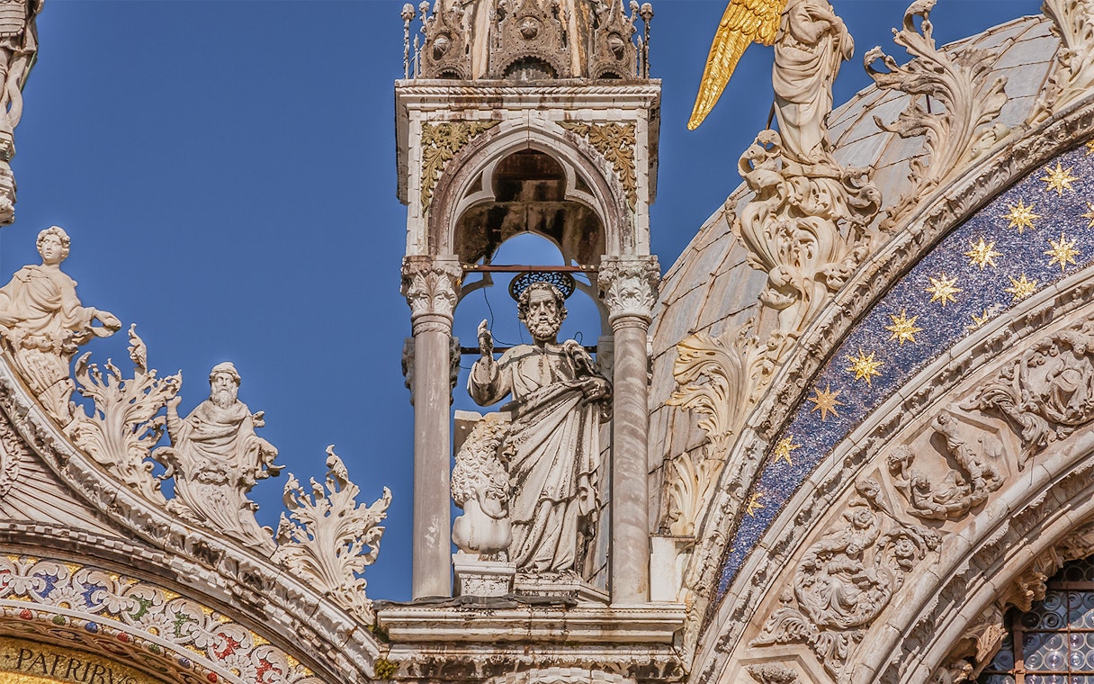 St. Mark's Basilica facade with detailed sculptures and ornate decorations in Venice.