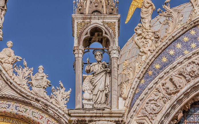 St. Mark's Basilica facade with detailed sculptures and ornate decorations in Venice.