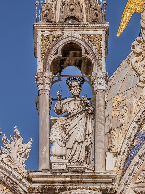 St. Mark's Basilica facade with detailed sculptures and ornate decorations in Venice.