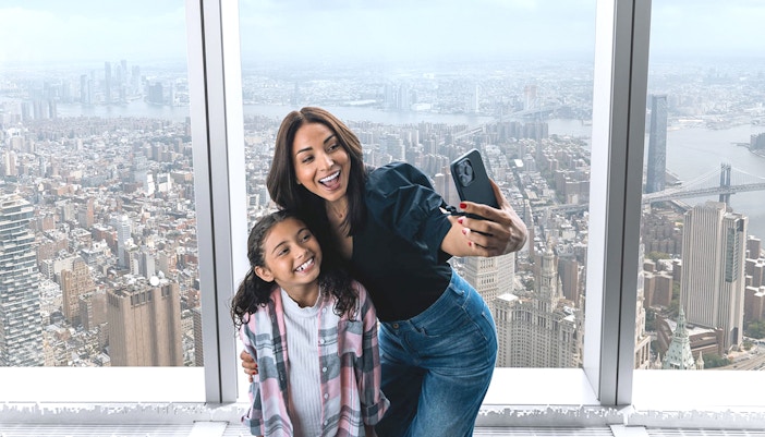 Tourists enjoying the panoramic city view from One World Observatory with Deluxe Skip-All-Lines Ticket in New York